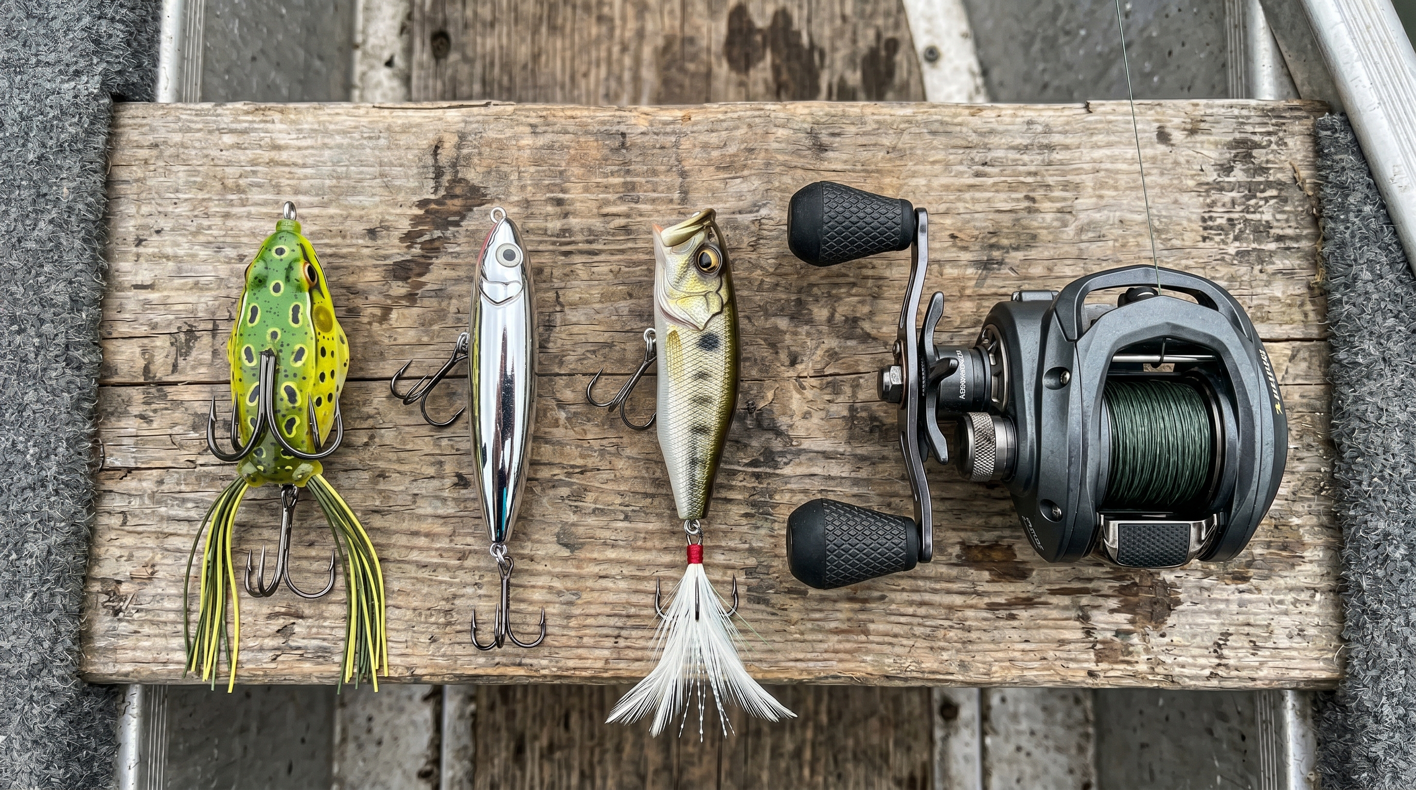 Flat-lay photography of topwater fishing lures and tools